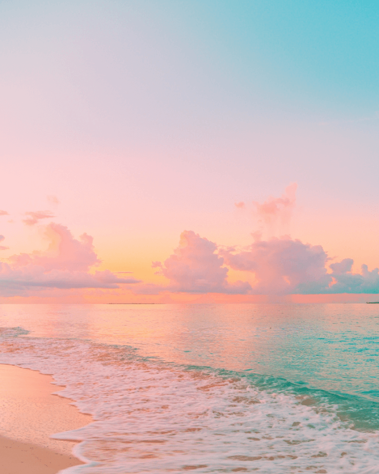 A pastel coloured sunset over a calm and lovely beach. Business goals and aspirations.