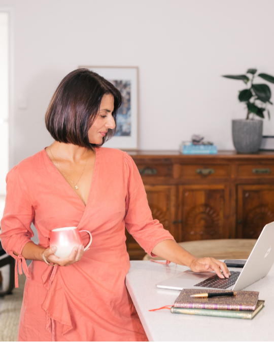 Bamik Baker, founder of Optimised Digital. Marketing expert on her laptop.