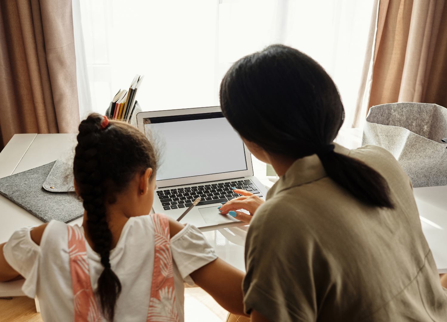 Parent and child learning together at a laptop