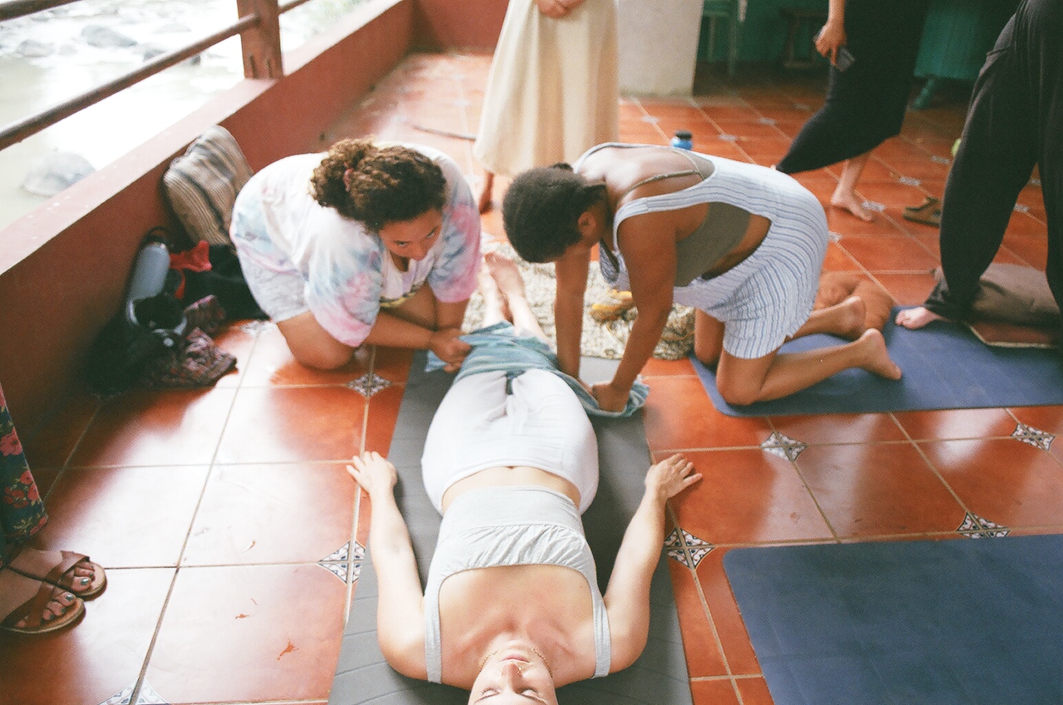 Students practising bodywork together on the floor