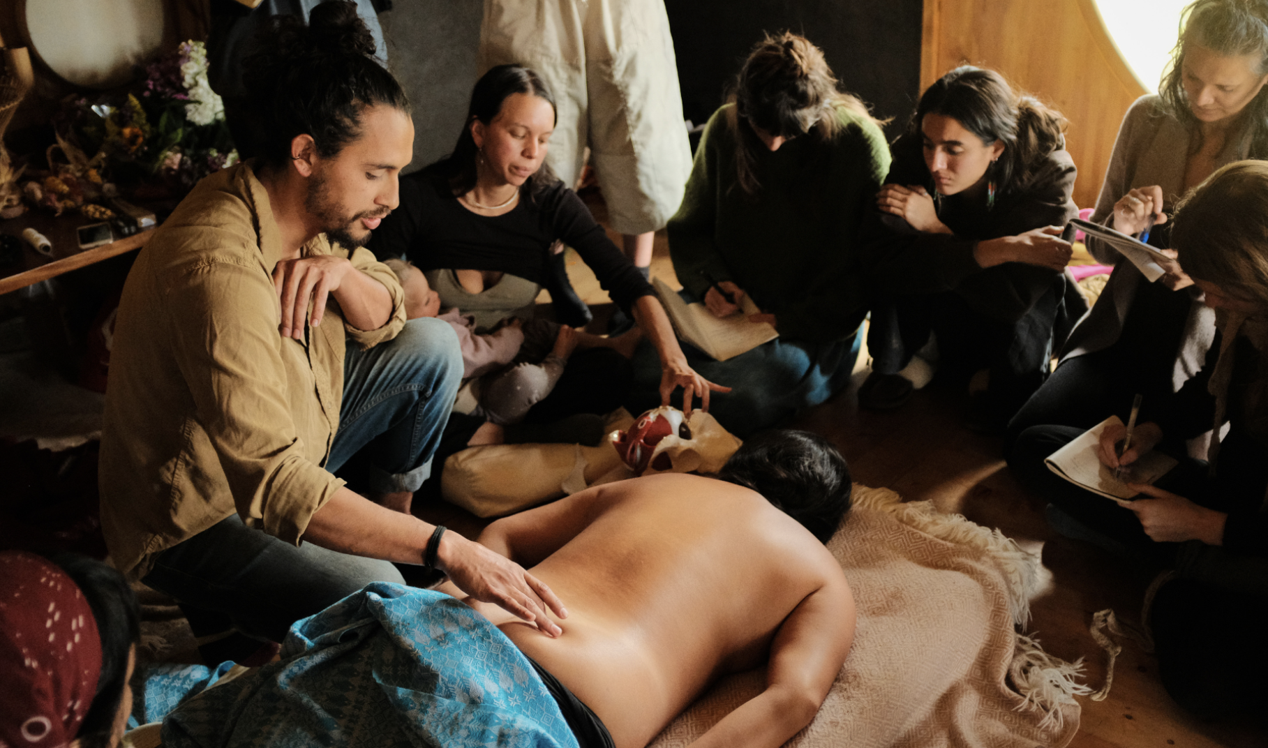 The cohort gathered around a demonstration of back work