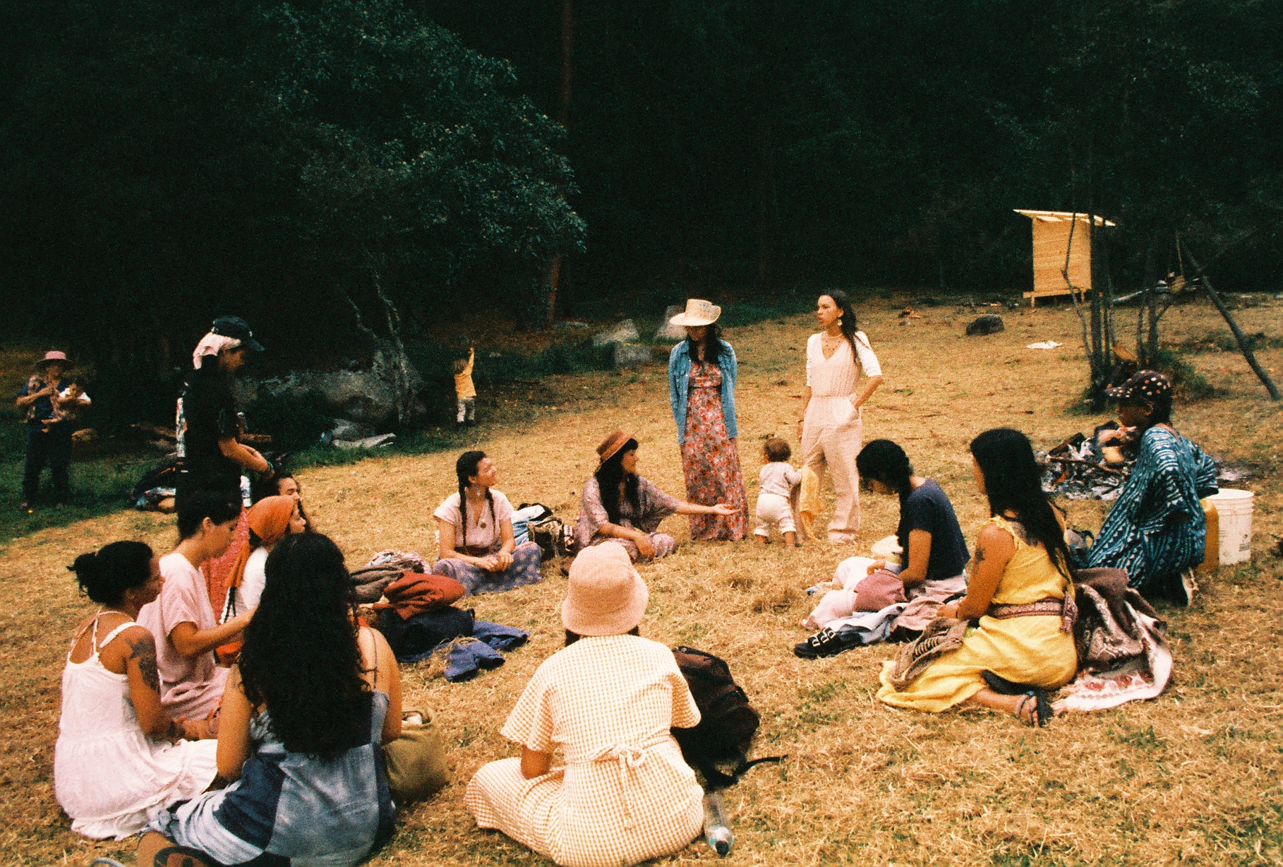The circle gathered on the grass at Finca Ocelote
