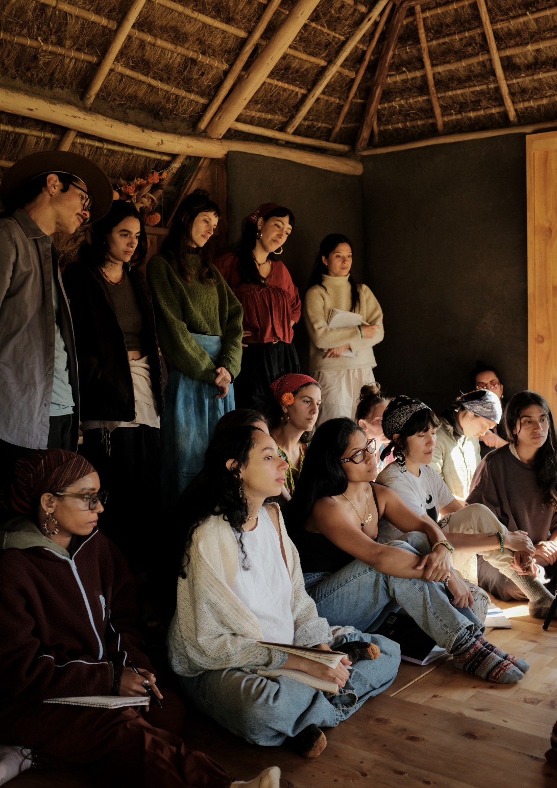 The cohort listening together in the round house