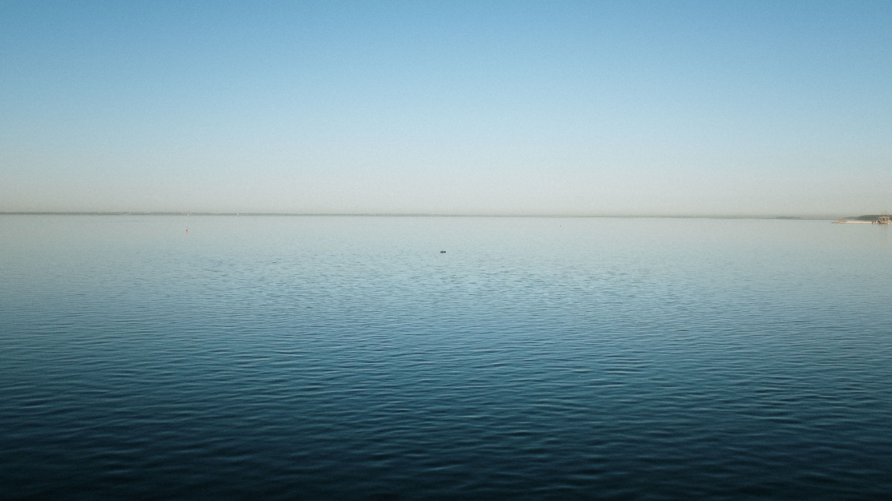 Calm body of water representing peace, steadiness, and emotional stability.