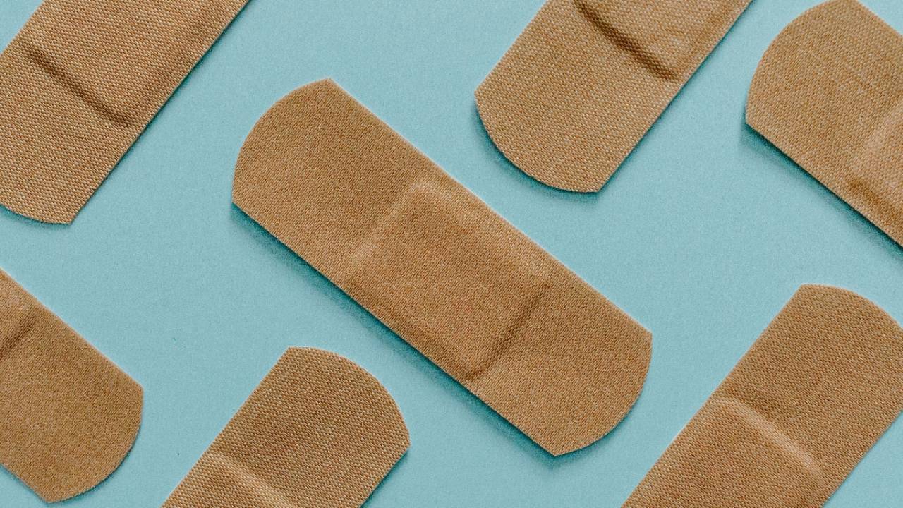 Bandaids arranged in a pattern representing repair and healing in a marriage.