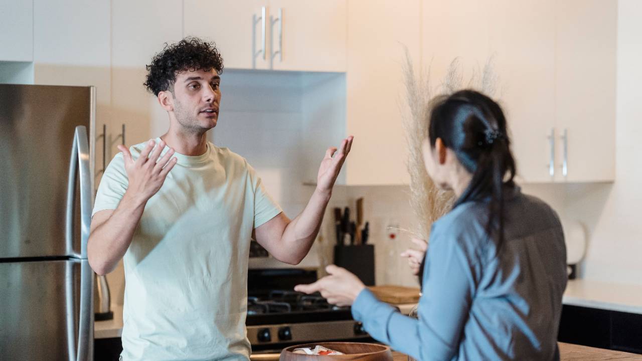 Couple arguing angrily, gesturing at each other during a heated disagreement