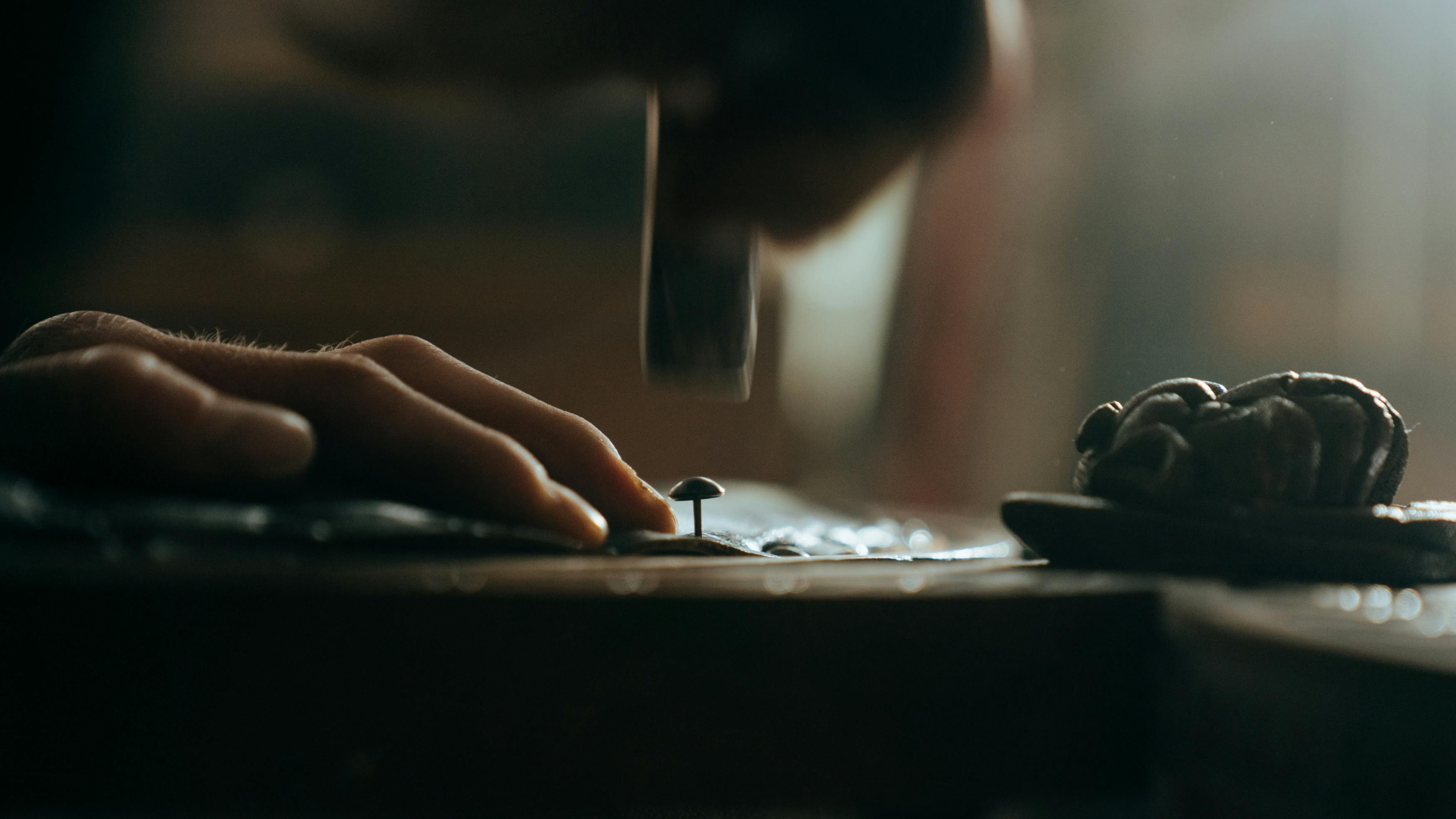 Man hammering a nail into wood, symbolizing problem-solving and the instinct to fix issues in marriage and relationships
