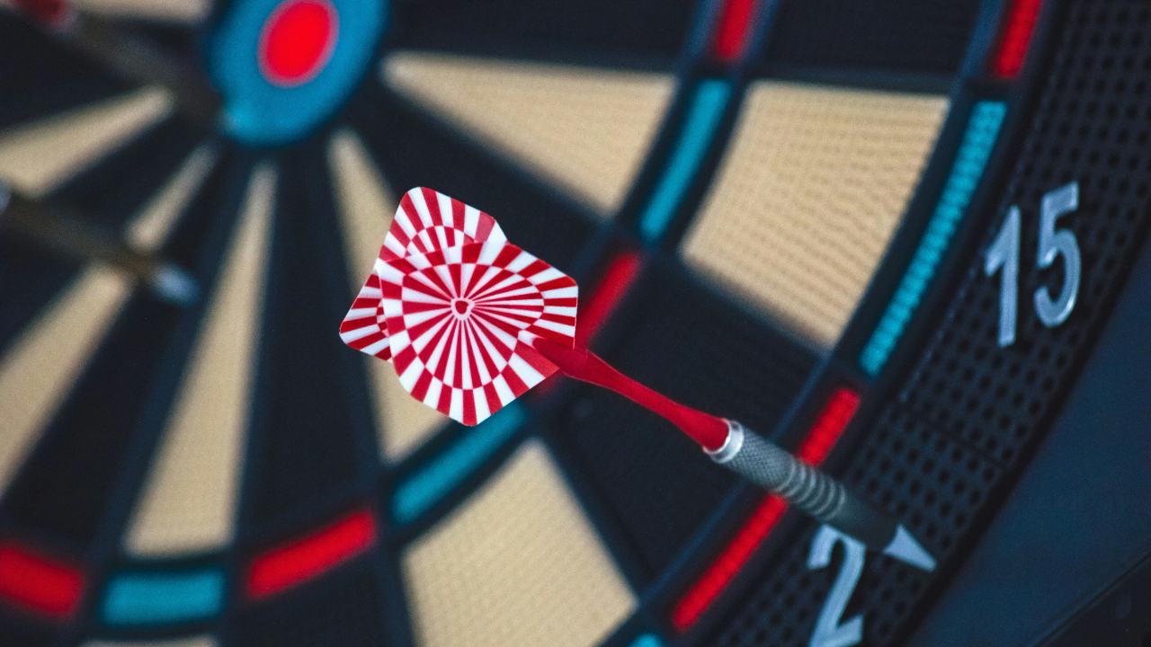Dart landing just outside the scoring area on a dartboard, symbolizing missed connection and miscommunication in marriage
