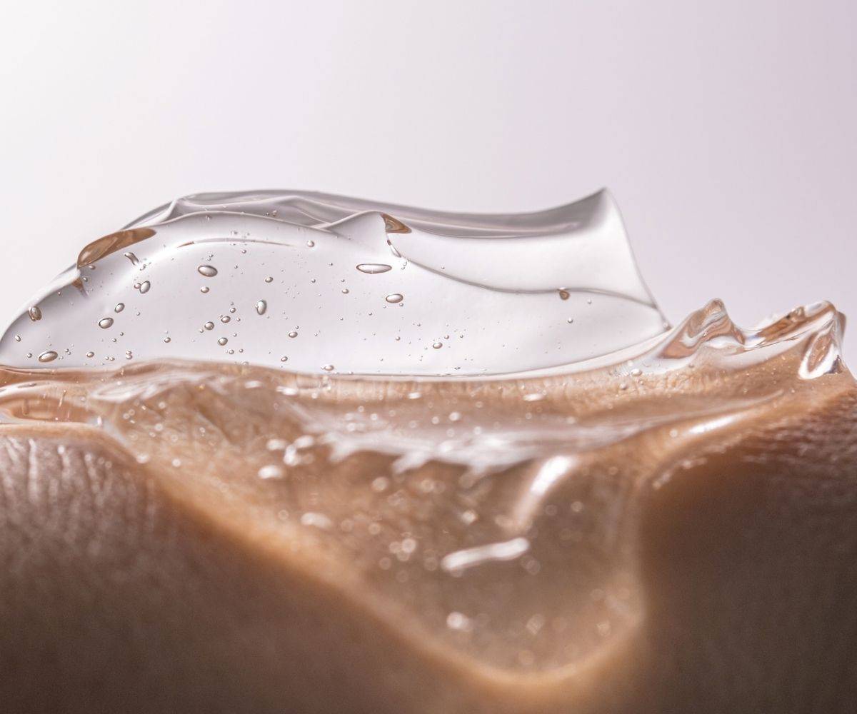 Close-up of a clear skincare formulation on skin