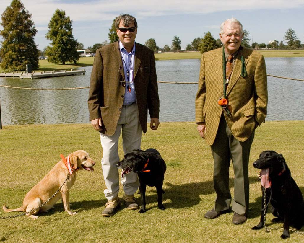 Frank and Rob Leatherbury with their retrievers at a polo match