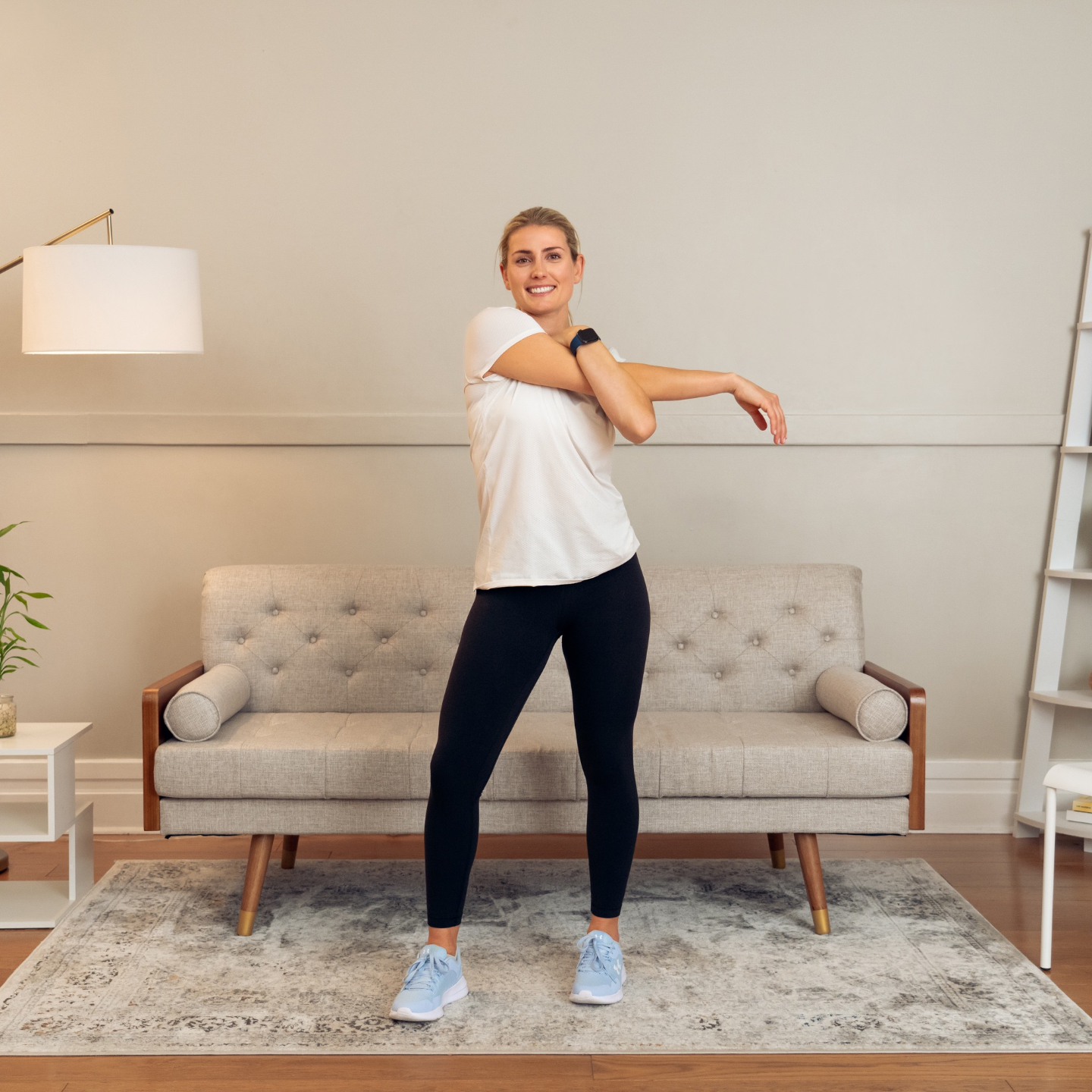 Woman stretching during an at-home mobility routine.