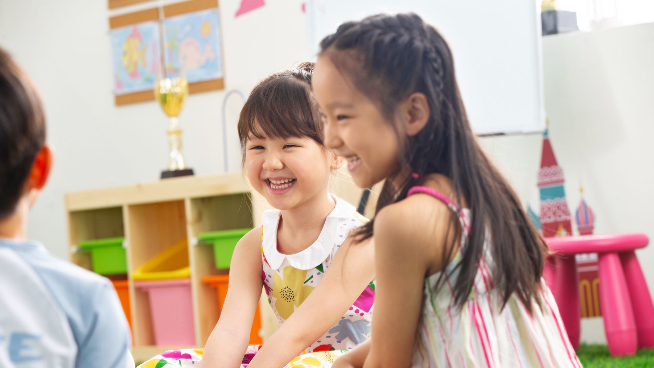 two girls making friends with another child