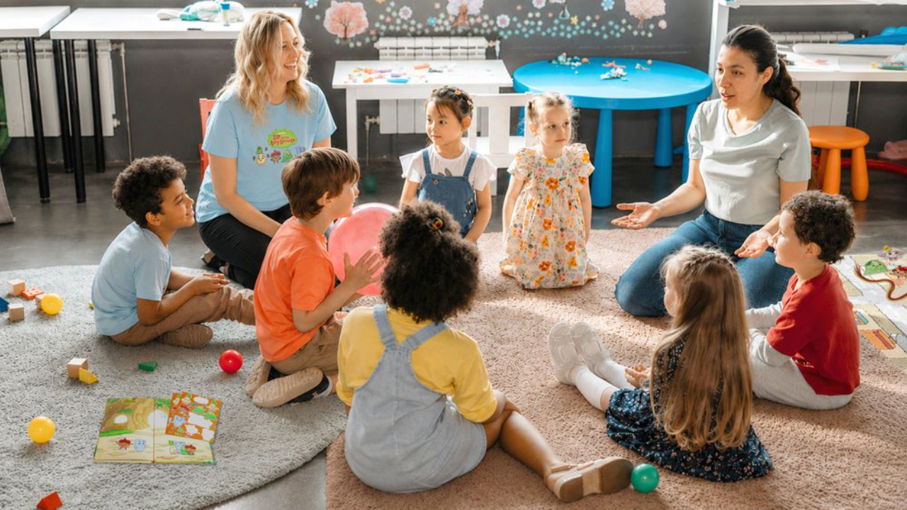 Woman teaching a young boy and girl about patience through taking turns during play