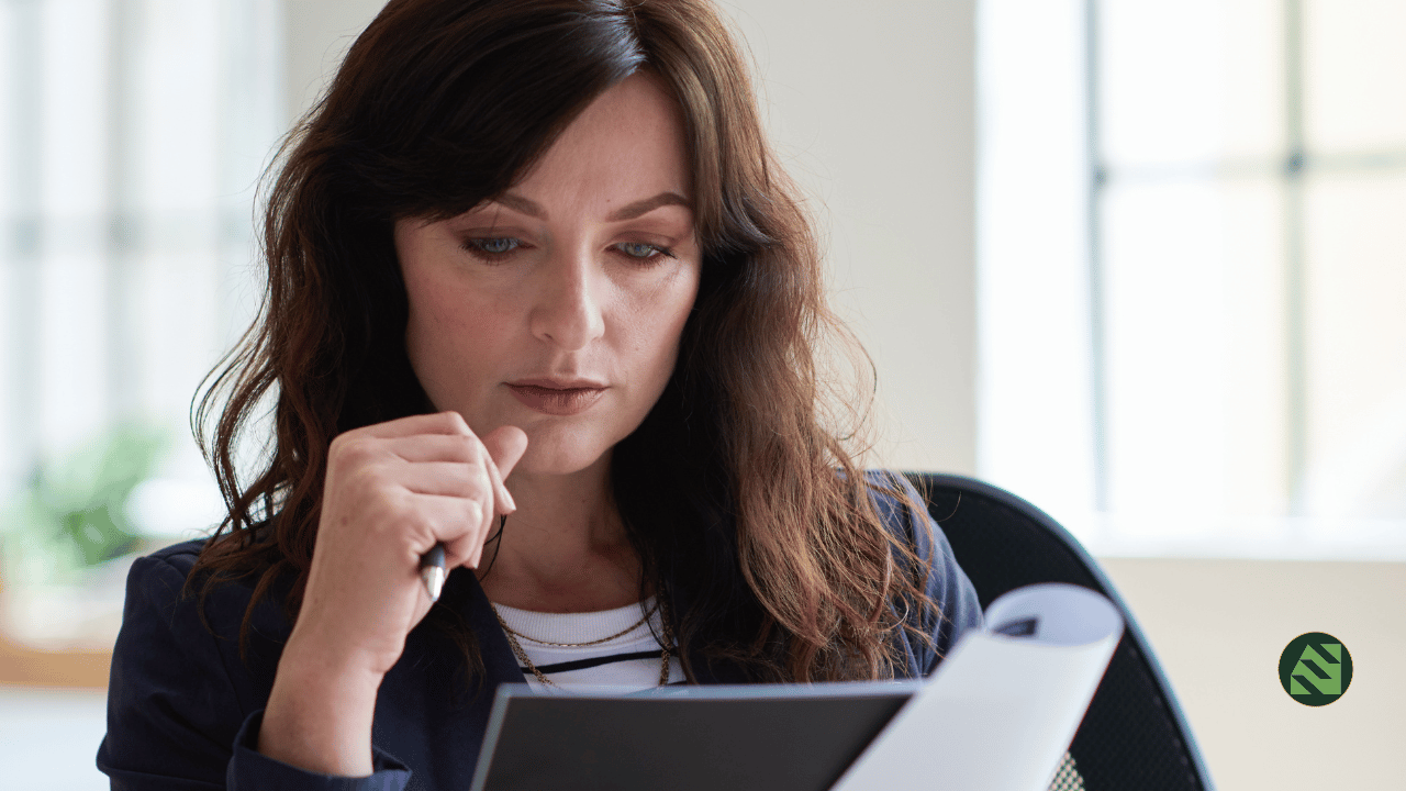 An entrepreneur reviewing a significant business decision at a desk