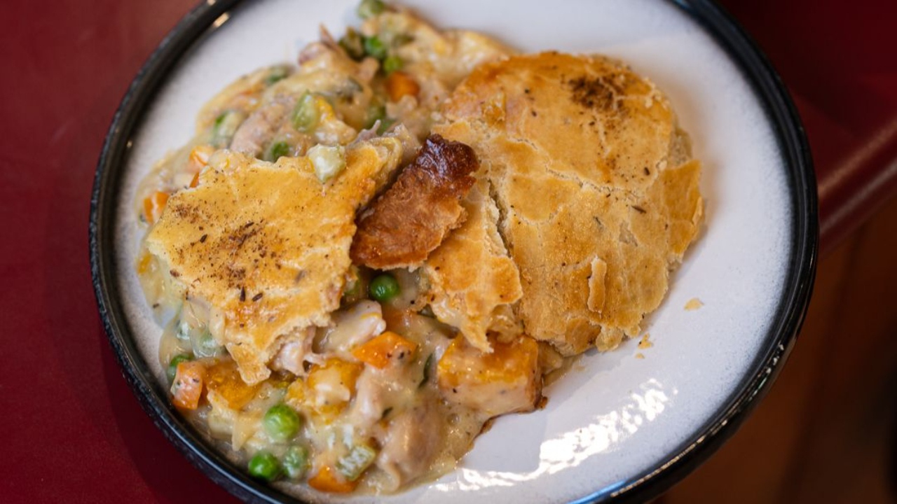 Homemade chicken pot pie with golden fennel shortcrust pastry served up on a plate