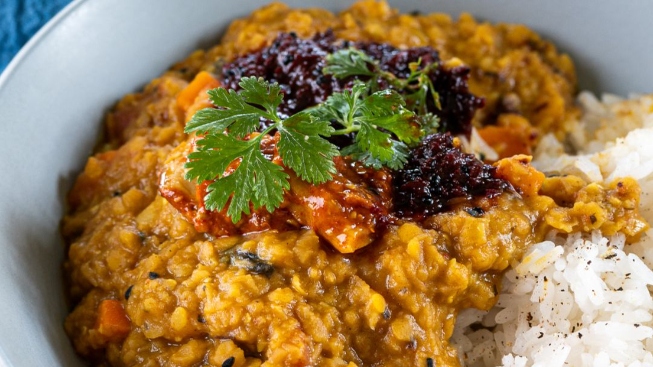 Vibrant, lentil curry with fluffy white rice.