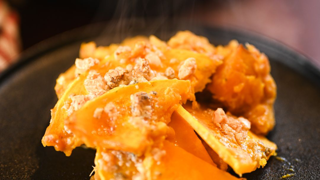 Golden butternut squash and blue cheese bake fresh from the oven served on a plate