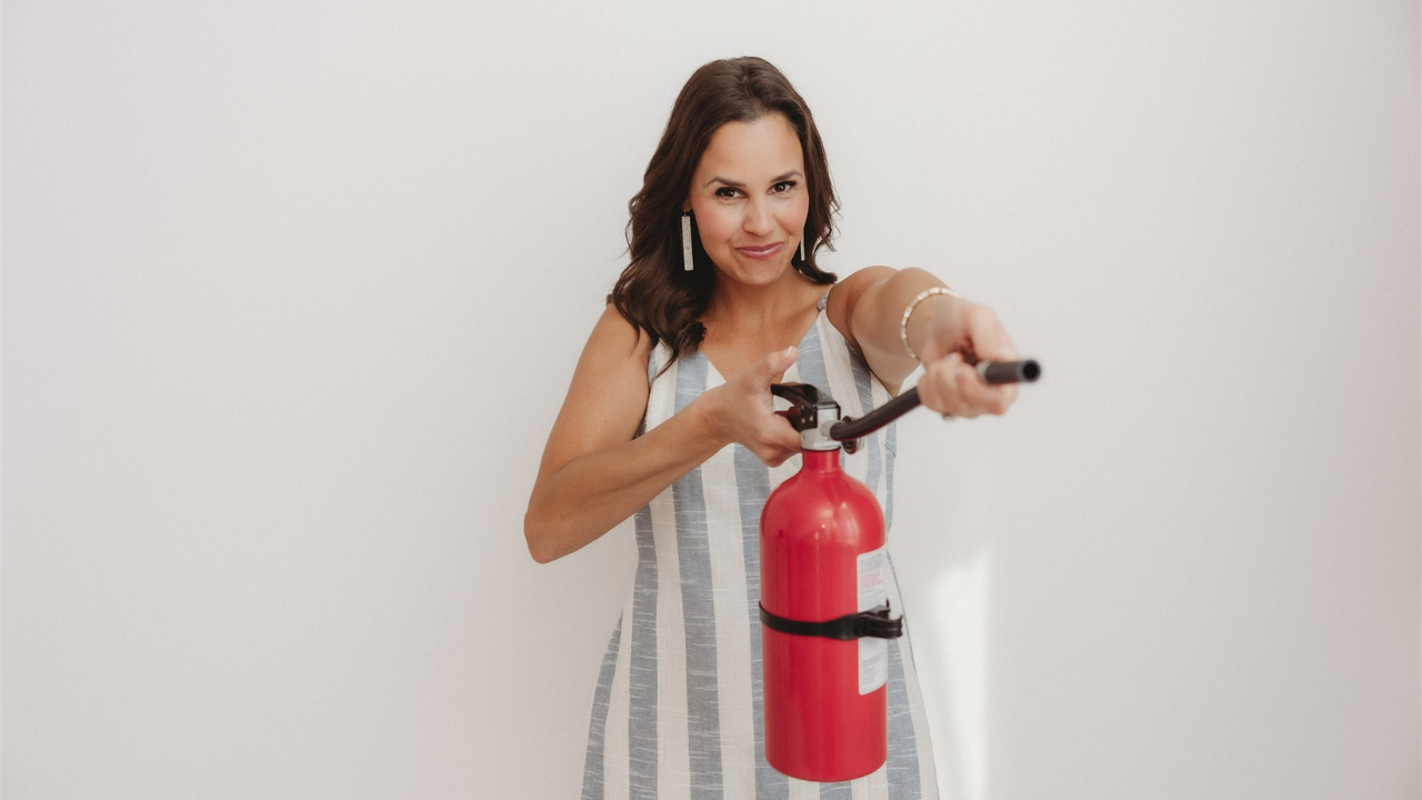 Dr Sheena holding a fire extinguisher pointing it towards "the flame" (inflammation) 