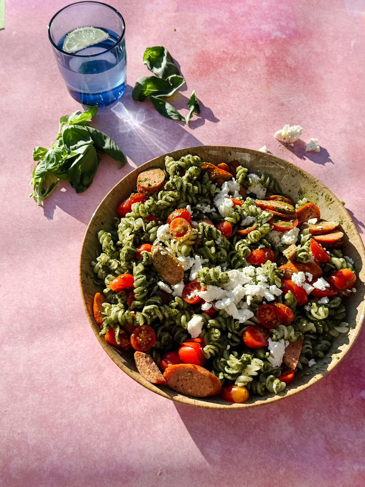 Pesto pasta with tomatoes and sausage
