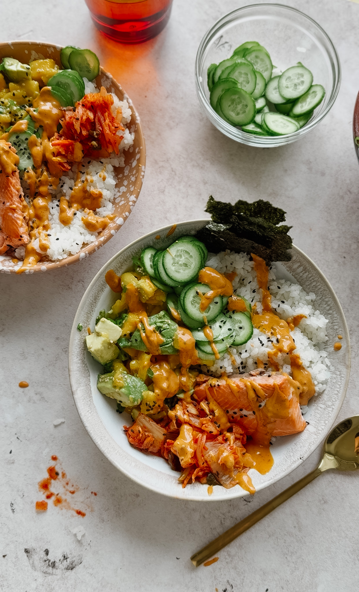 Salmon sushi bowl with cucumber and kimchi