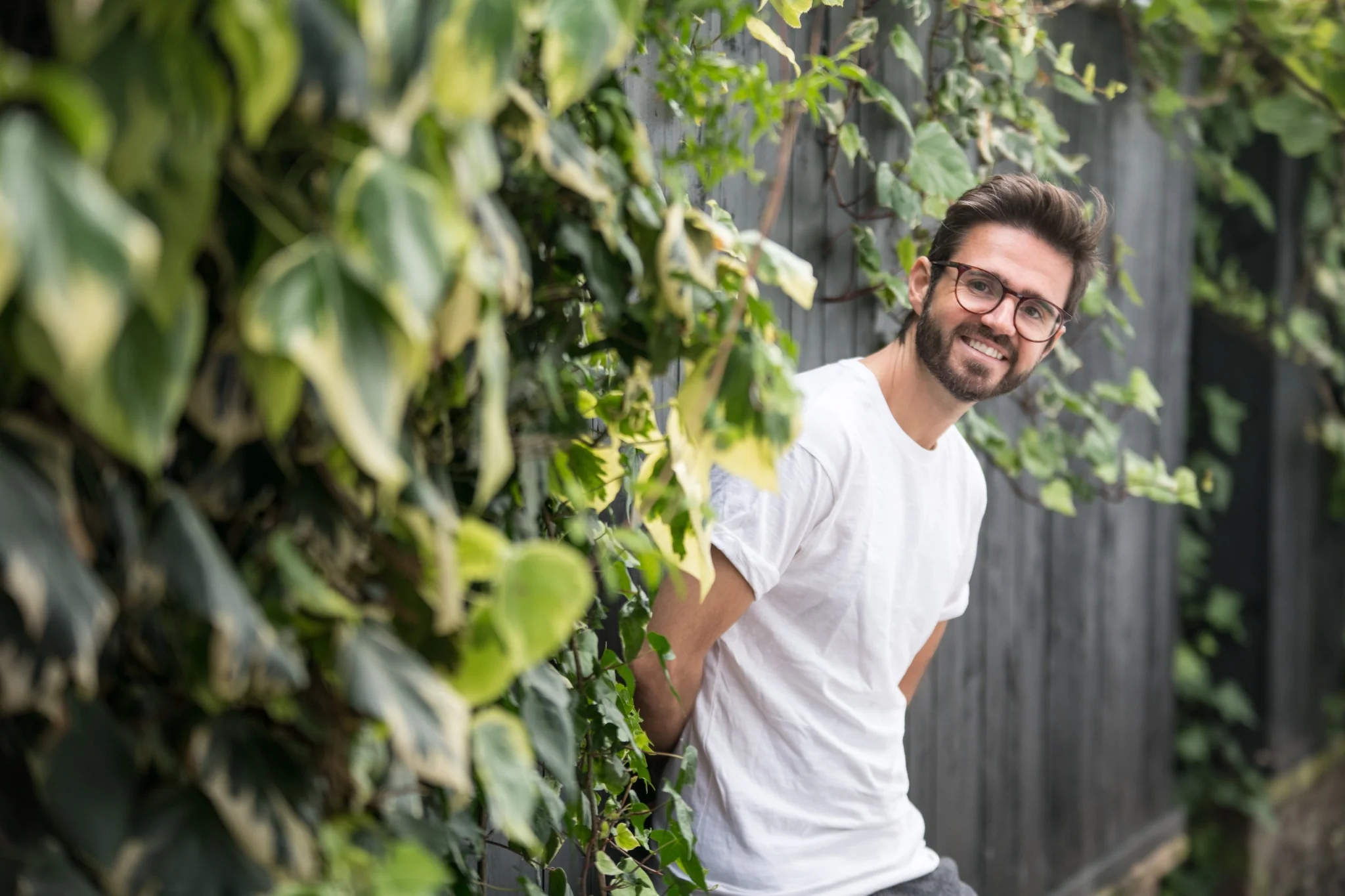 Jimmy Wightman smiling beside leafy greenery