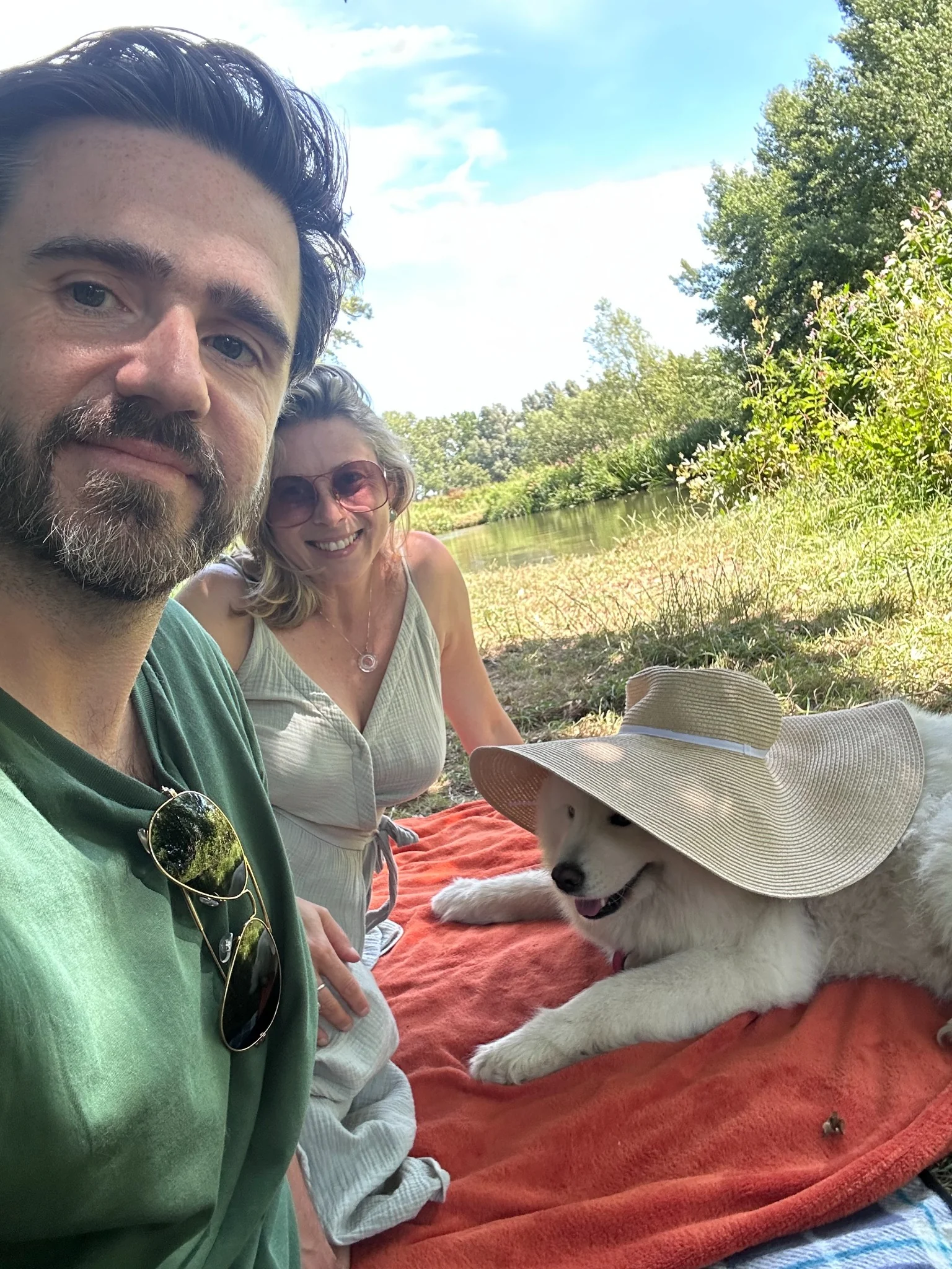 Jimmy and Magdalena enjoying a picnic beside the pond with Luna