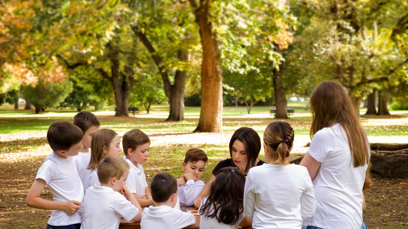 Children gathered outdoors for seasonal art activities, creating together in nature with simple creative art ideas for kids.