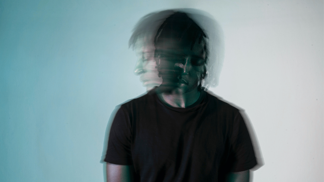 Man with face blurred to symbolize someone who is wounded by trauma and unsure which direction to go with faith.