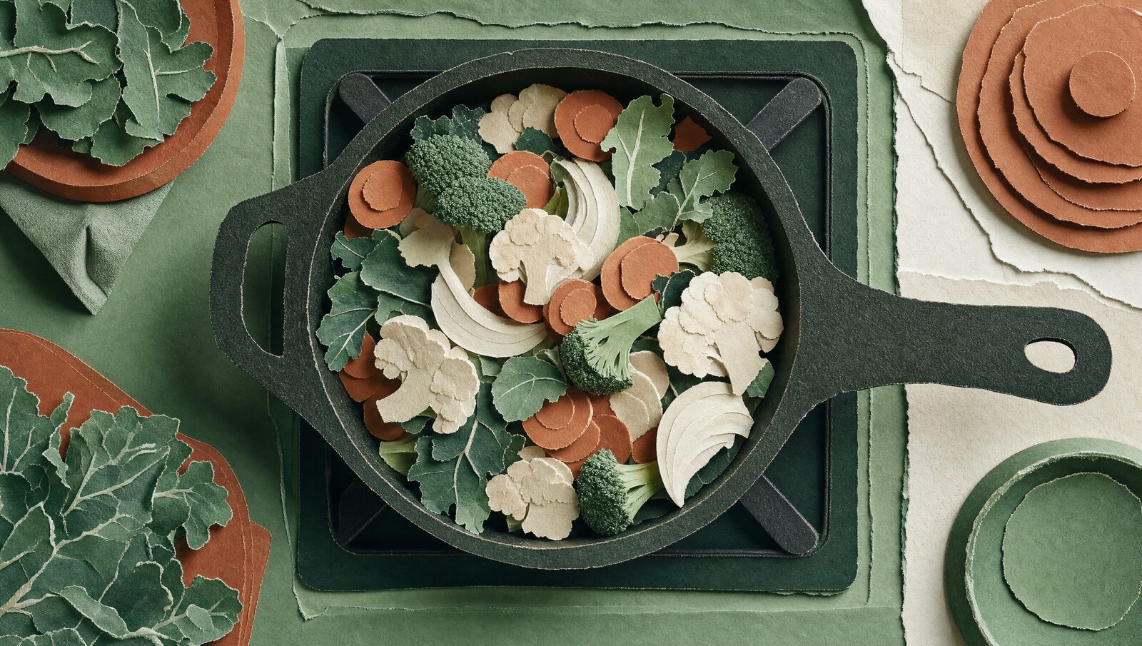 A cut-paper stove with a pan sitting on an unlit burner