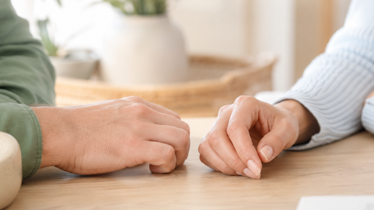 Two hands resting near each other, symbolizing rebuilding trust after betrayal