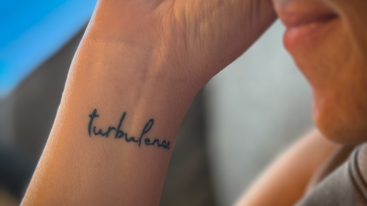 Carrie showing her turbulence tattoo
