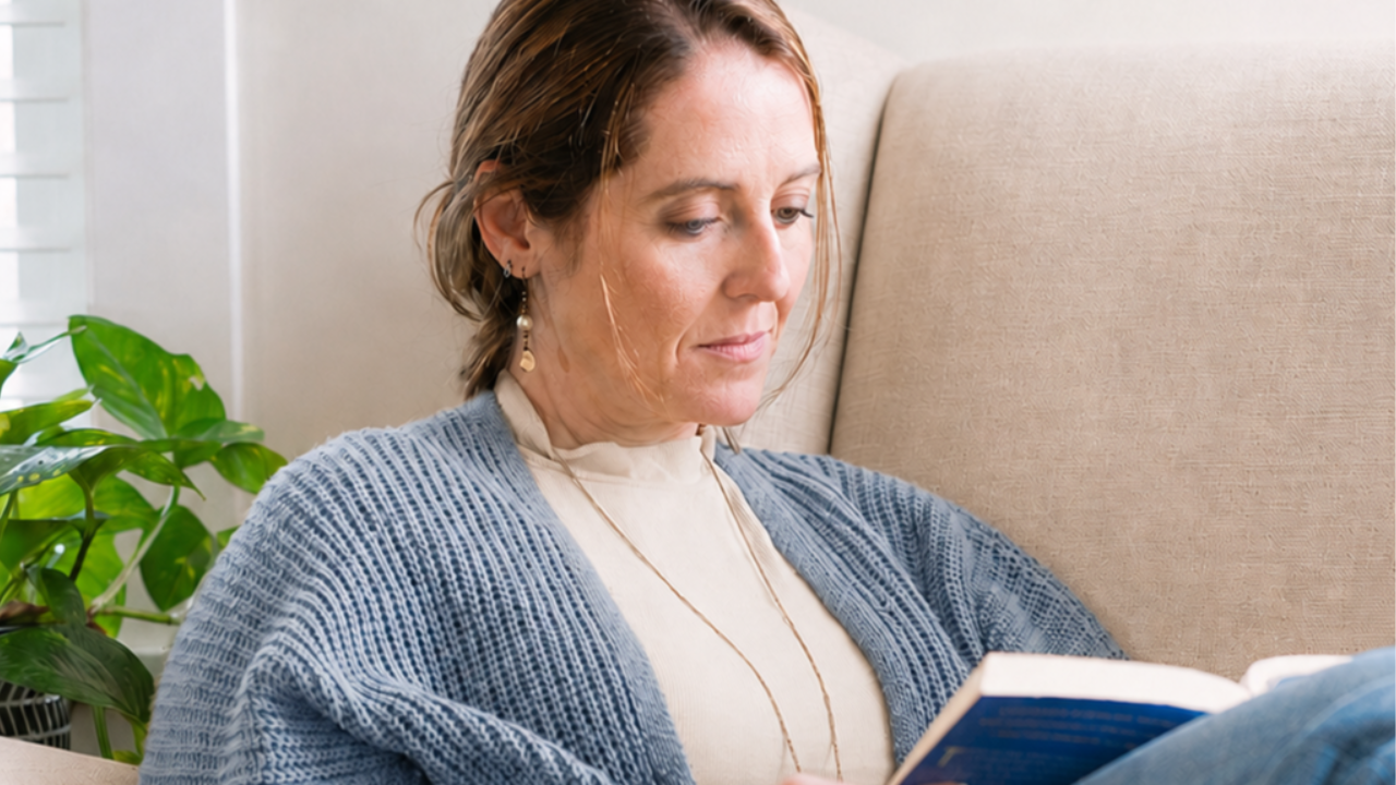 Woman in seat reading a book