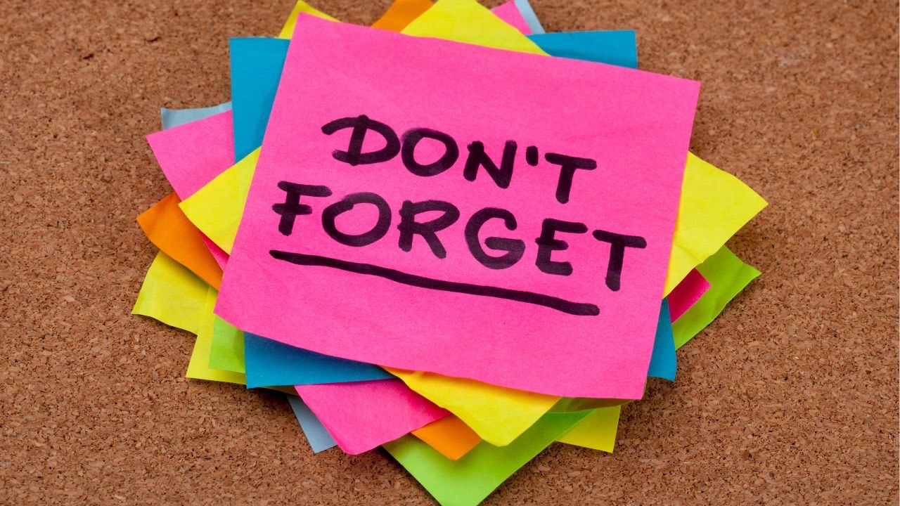 A stack of colorful post-it's with "Don't forget" written on the top one. 