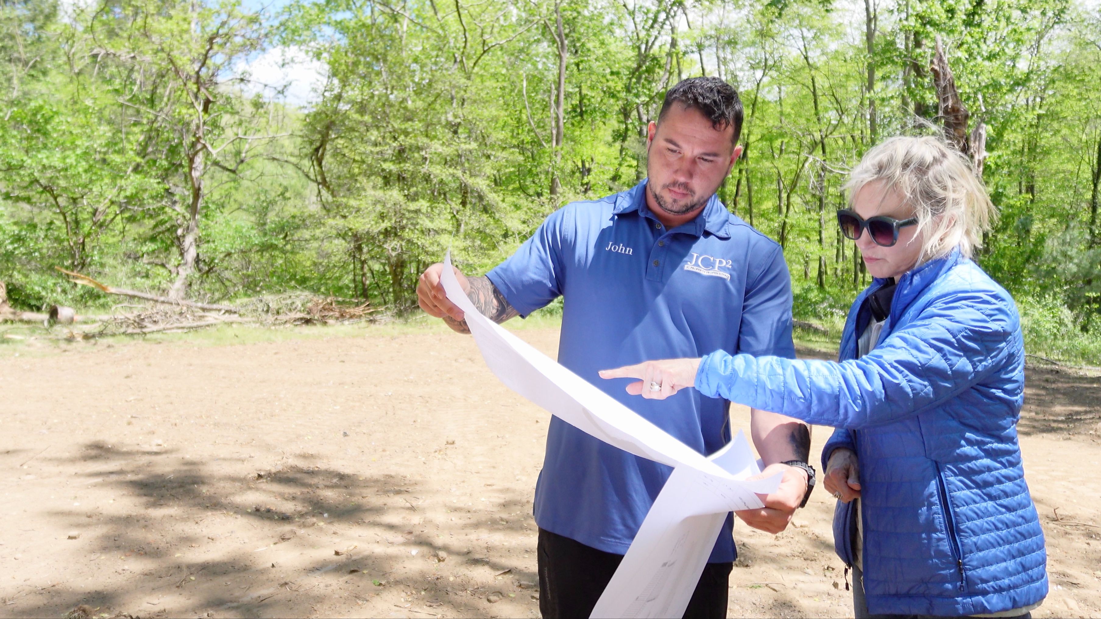 John Seaman looks at house build plans with customer