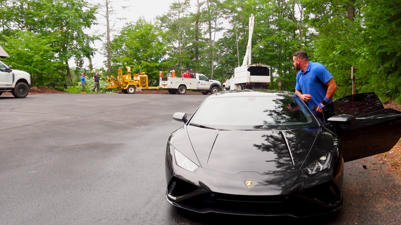 John Seaman getting into his Lamborghini on a tree job site.