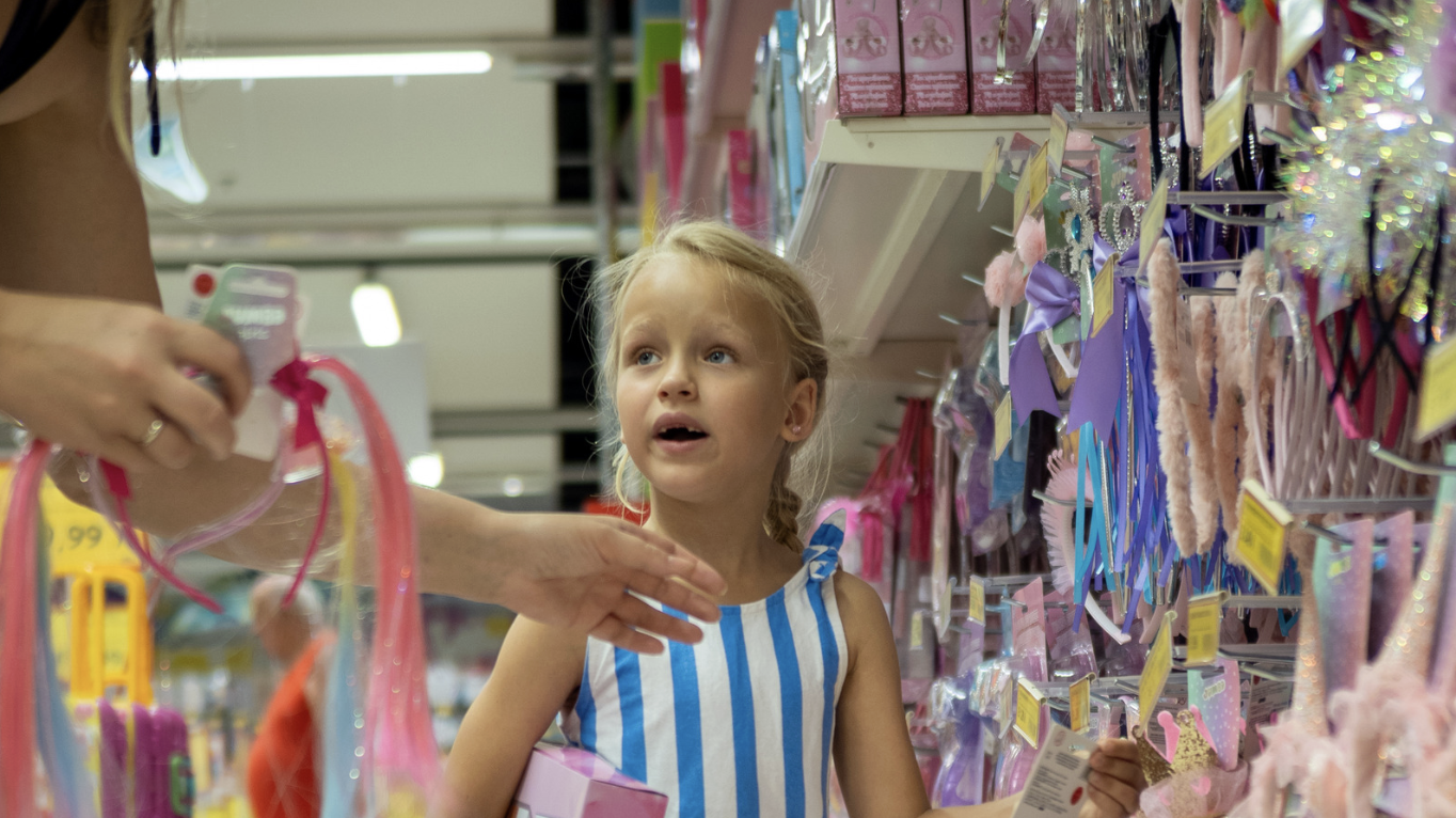 a little girl shopping with her mom