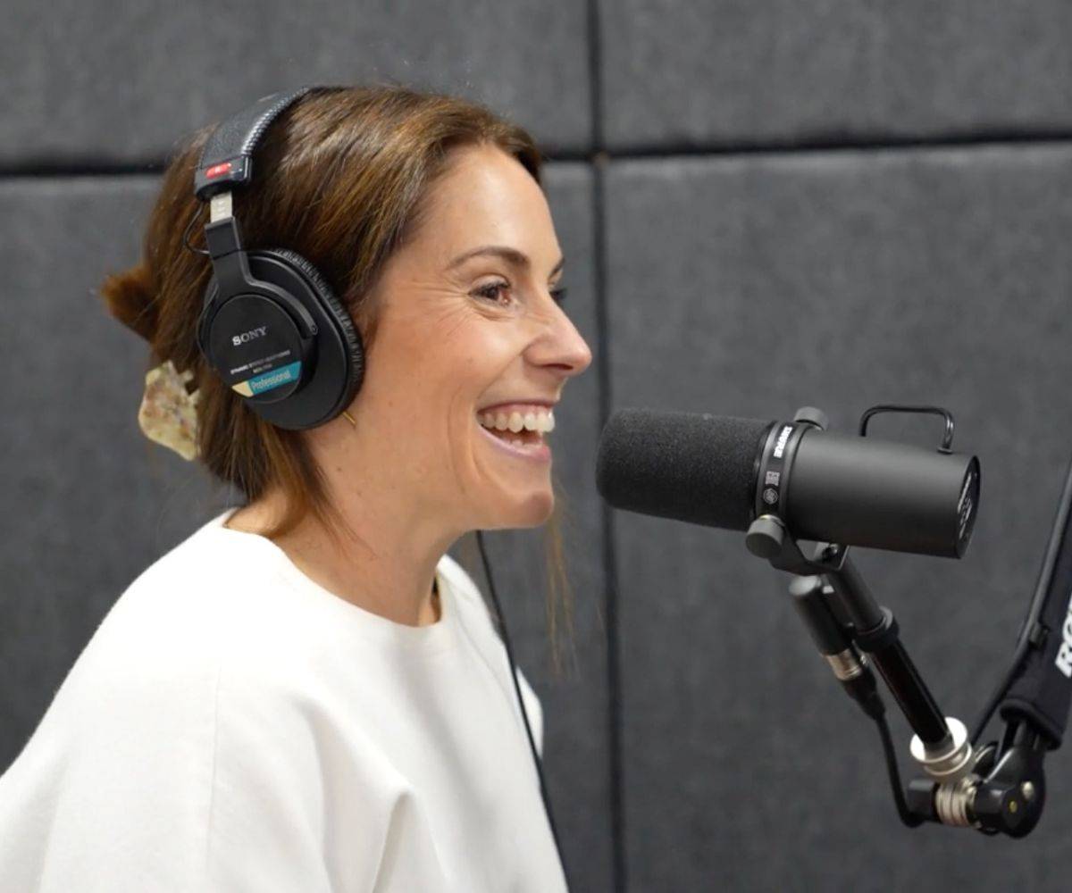 Tiffany laughing into the microphone while recording the Life of And podcast.