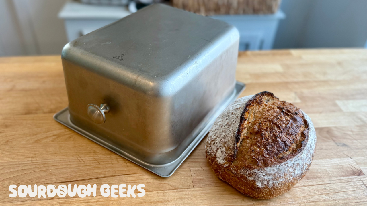 A half hotel pan turned into a baking shell by addition of a handle to one of the surfaces