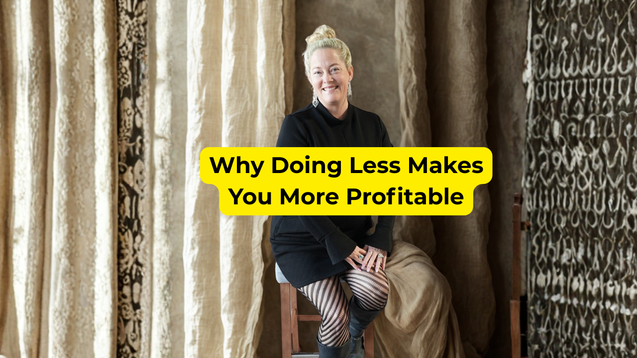 Woman in black dress sitting on a bar stool smiling