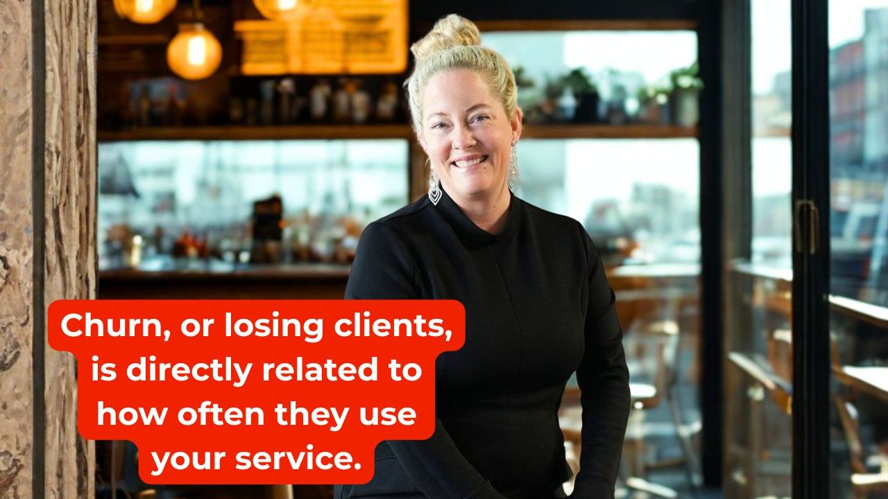 woman in black dress smiling with words on the screen that say churn, or losing clients, is directly related to how often they use your service.