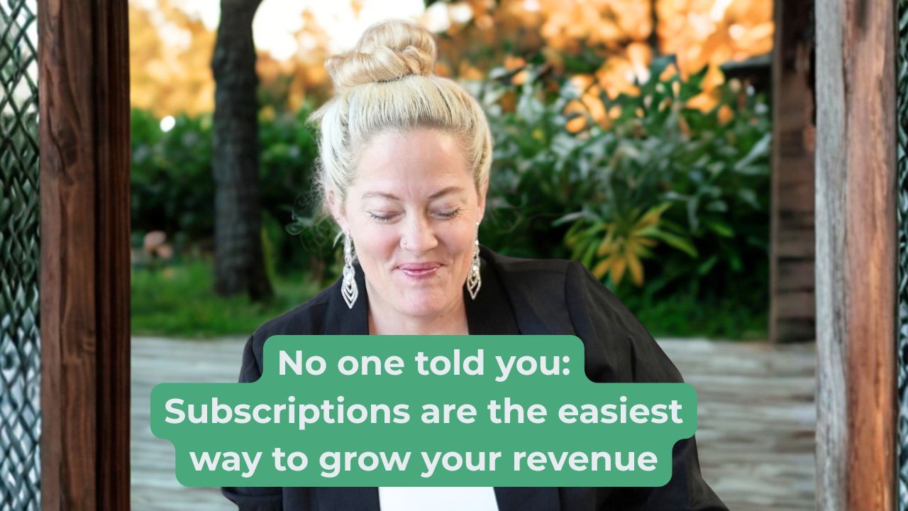Woman in black blazer and white shirt looking down and smiling with words on the screen that say "No one told you: Subscriptions are the easiest way to grow your revenue"