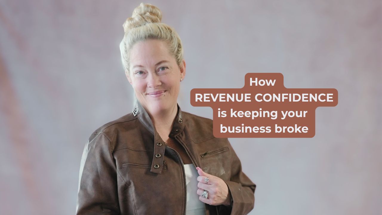 Woman in brown leather jacket smiling with words on the screen that say, "How REVENUE CONFIDENCE is keeping your business broke"