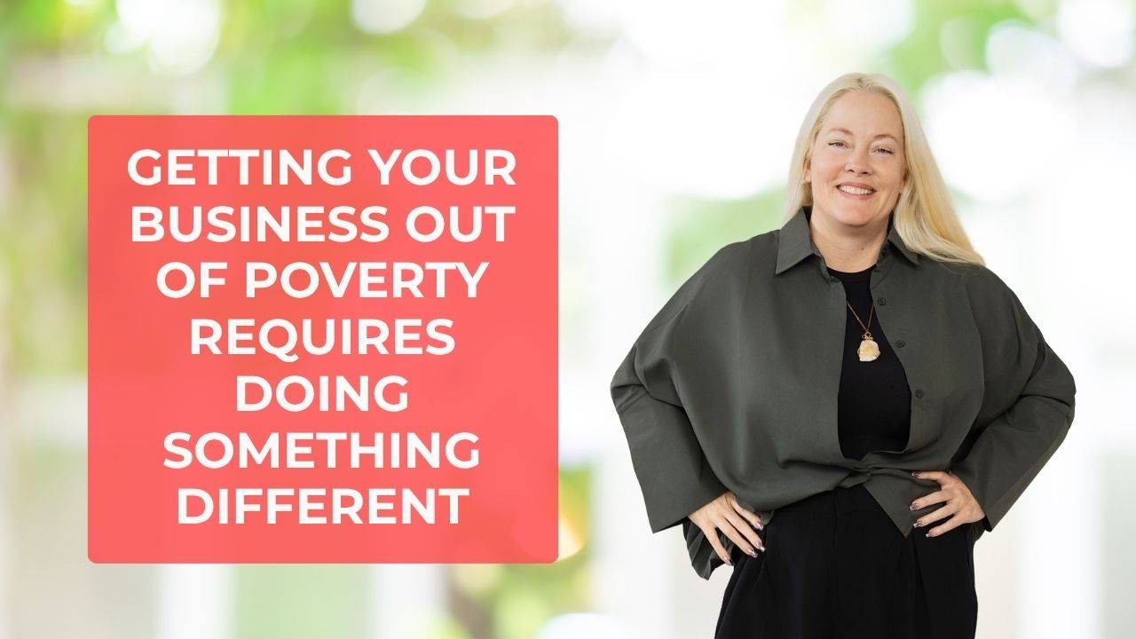 Woman in black shirt, black pants, and grey coat, smiling, with her arms on her hips and words on the screen that say, "Getting Your Business Out of Poverty Requires Doing Something Different"