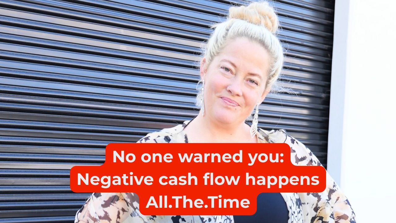 Woman in black shirt and floral shawl smiling with words on the screen that say, "No one warned you: Negative cash flow happens All.The.Time"