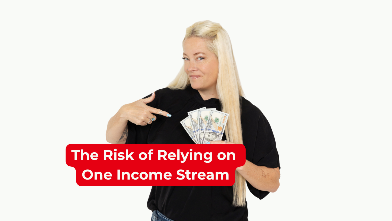 Woman in black shirt pointing at money she is holding in her hand and smiling