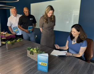 Vered Kogan signing an UNSTUCK book with attendees