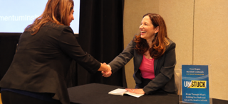 Vered Kogan greeting an attendee at a book signing at Change Orlando