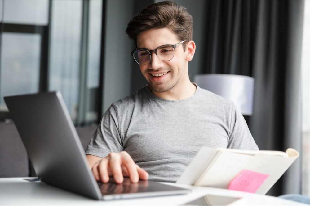 Man looking at a computer smiling