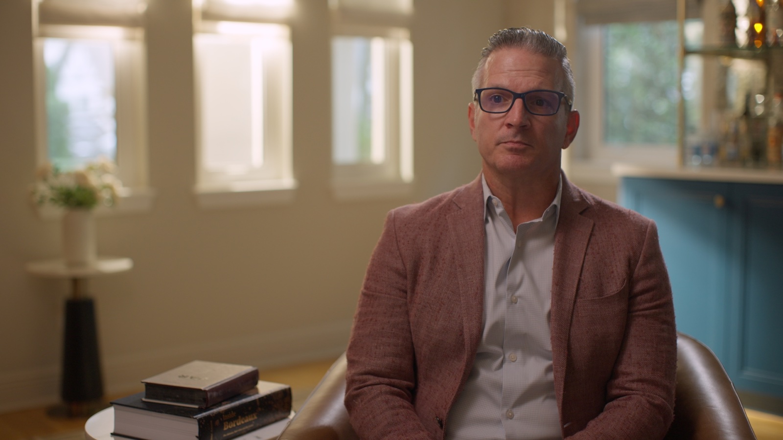 Finished interview frame with shaped window light in the background and controlled contrast on the subject