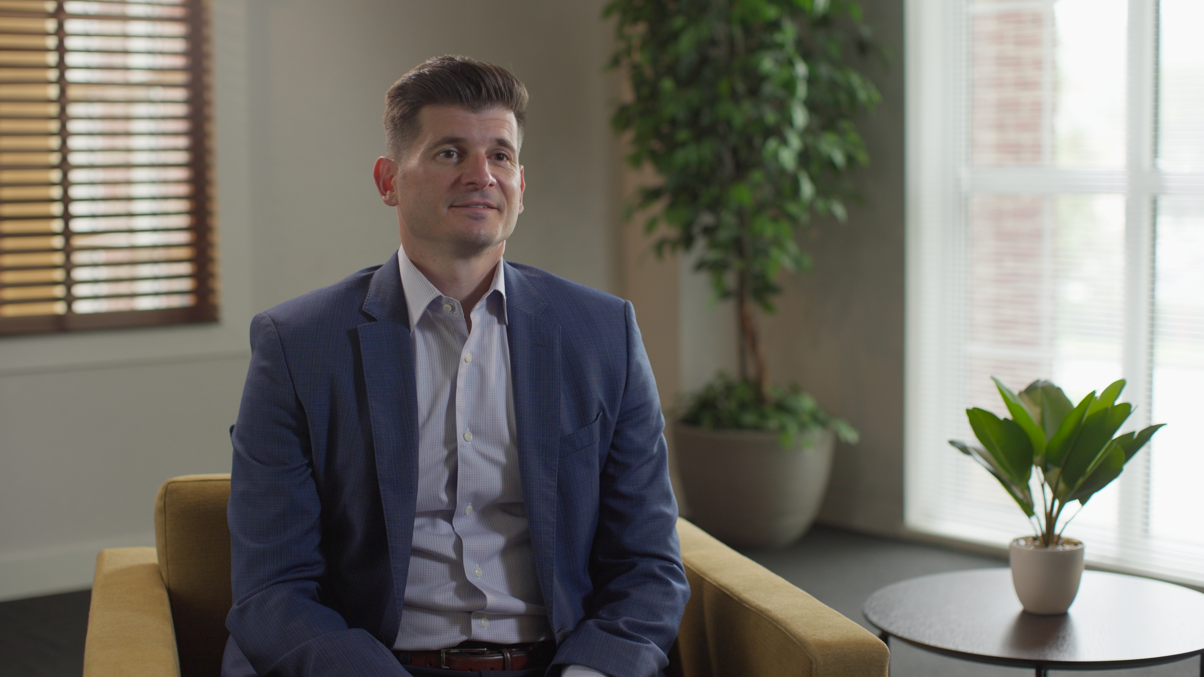 Finished interview frame with a naturally balanced key, warm background, and window edge light